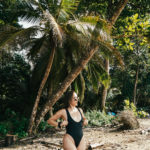 Women standing under palm tree in Punta Uva Puerto Viejo Costa Rica