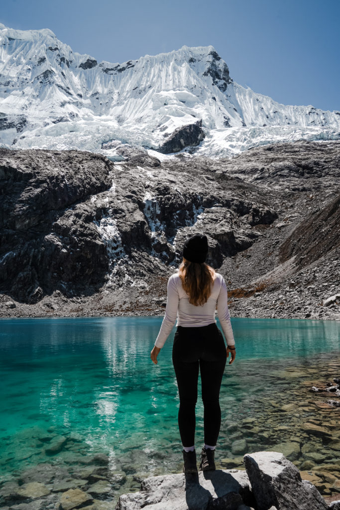 Solo female traveler posing at Laguna 69 in Huaraz Peru