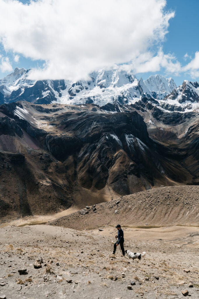 Man and a dog hiking Huayhuash